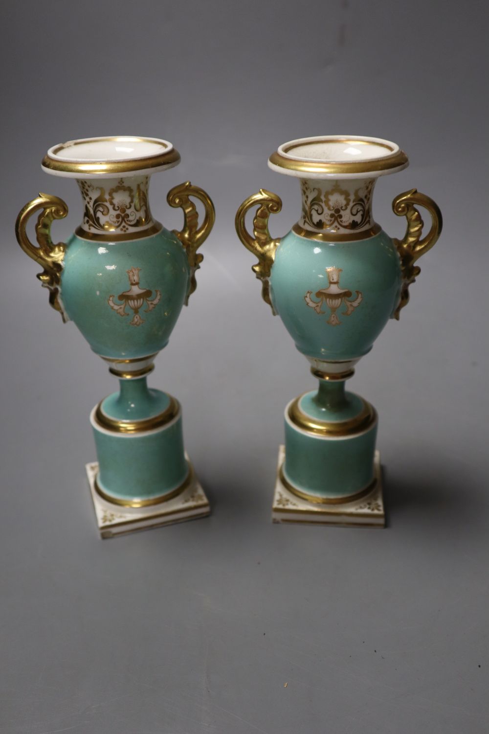 A pair of Grainger Worcester two handled vases painted with named landscapes on a sea-green ground, 17.5cm